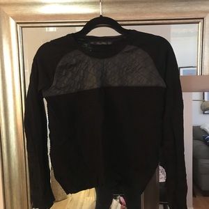 Black ribbed sweater with faux leather accent
